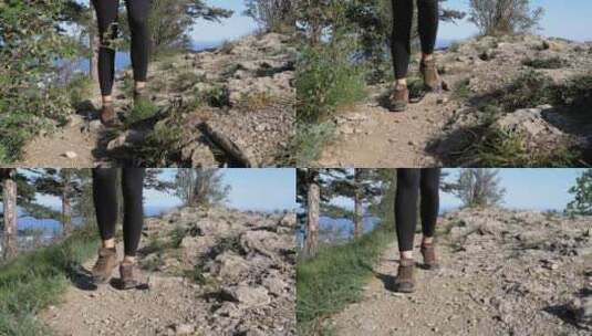 徒步登山妇女在悬崖顶上徒步的脚在岩石上行高清在线视频素材下载