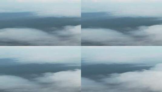 云雾中若隐若现的崖壁山高清在线视频素材下载