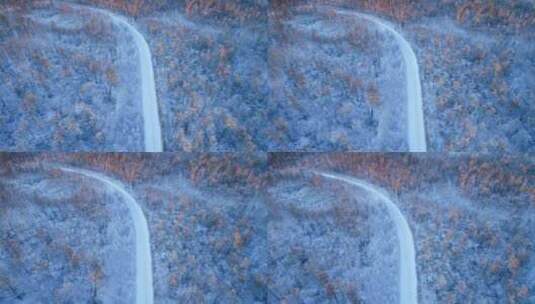 航拍穿越大兴安岭冬季雪林的山路高清在线视频素材下载