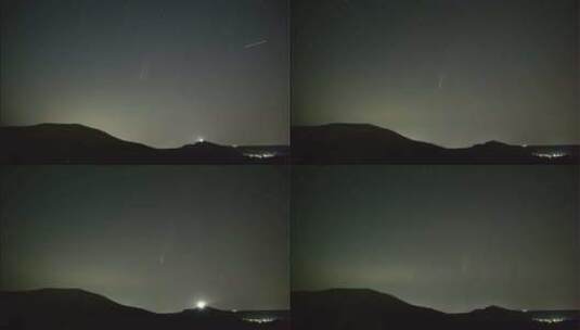 彗星在山丘和村庄上空的夜空运动延时高清在线视频素材下载