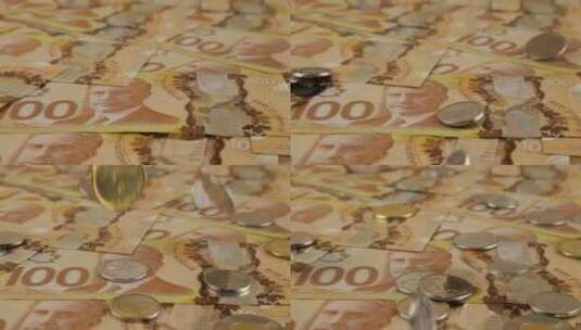 美元聚合物纸币上掉落的加拿大硬币高清在线视频素材下载