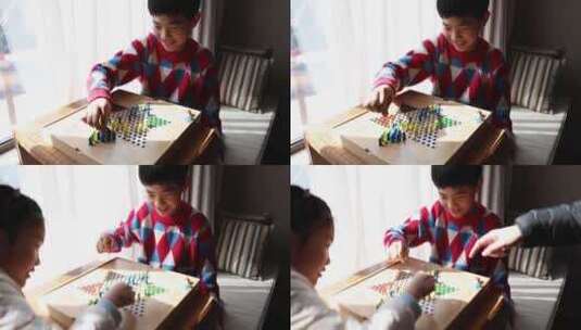 中国小孩在窗边下棋跳跳棋高清在线视频素材下载