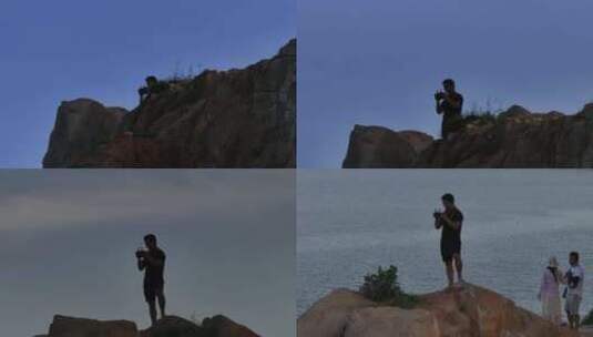 平潭岛站在石头顶上的男子高清在线视频素材下载