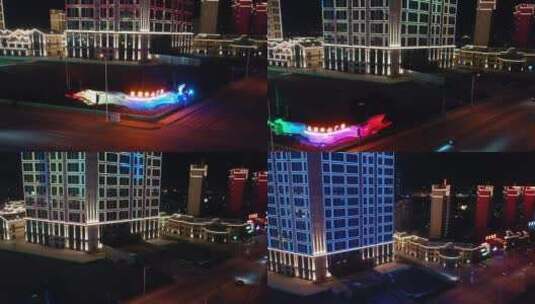 城市夜景大连庄河长河悦湖中心楼体亮化航拍高清在线视频素材下载