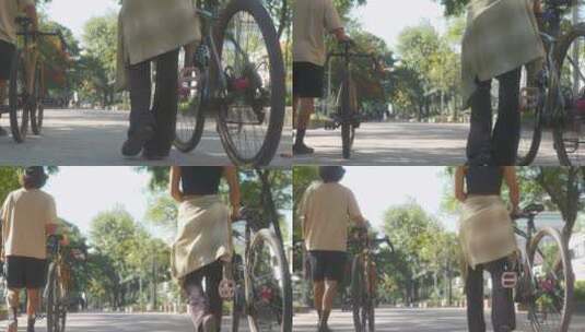 推着自行车在公园高清在线视频素材下载