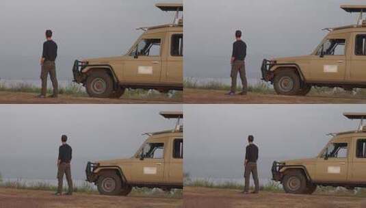 一名男性游客站在Safari前观看非洲风景高清在线视频素材下载