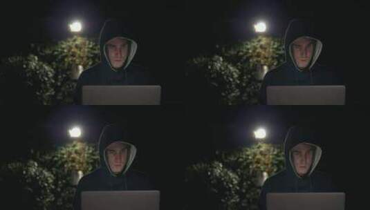 晚上坐在公园长椅上使用笔记本电脑的男子高清在线视频素材下载
