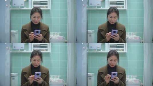 中年女性在卫生间使用手机高清在线视频素材下载