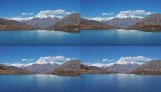 蓝色的湖泊和贡嘎雪山高清在线视频素材下载