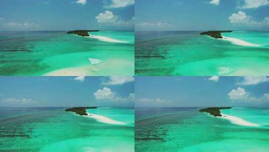 白天天堂阳光明媚的白色沙滩和水蓝色的水背景的岛屿景色高清在线视频素材下载
