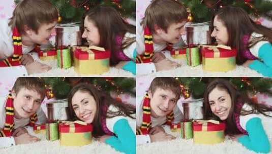 趴在圣诞树旁的情侣高清在线视频素材下载