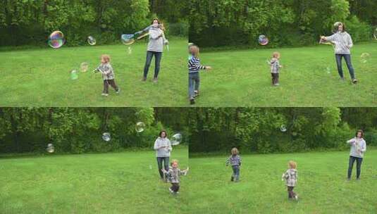 公园里快乐的家庭时刻，母亲在两个年幼的孩高清在线视频素材下载