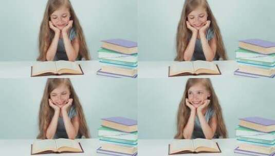 快乐的女学生在阅读桌上读书高清在线视频素材下载
