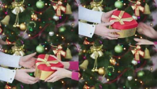 圣诞节男孩给女孩一个礼物的手部特写高清在线视频素材下载