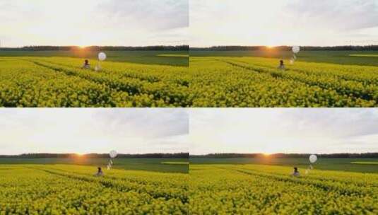 日落时分_带着白色气球走在花田上高清在线视频素材下载