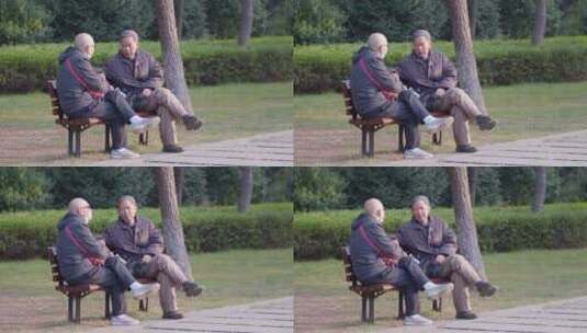 老年男人坐在公园长椅上聊天高清在线视频素材下载