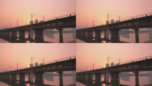 夕阳下在桥梁上行驰中的火车高清在线视频素材下载