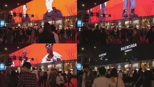 杭州延安路夜晚街道上大型宣传广告屏前人流高清在线视频素材下载