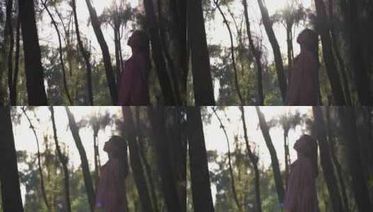 美女站在森林里感受自然的女孩融入自然环境高清在线视频素材下载