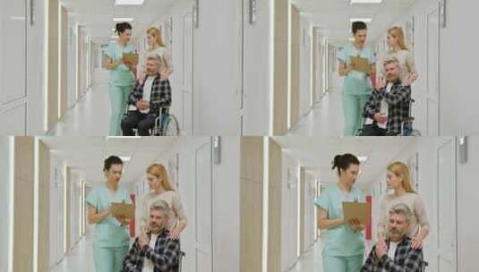 轮椅上的中年男子与护士和同伴在医院高清在线视频素材下载