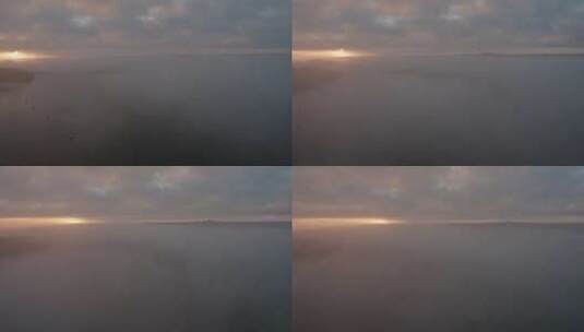 海面上的薄雾和云层，船只在黎明时分停泊在高清在线视频素材下载