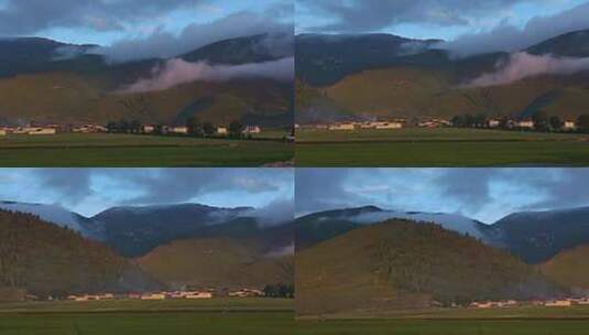 傍晚高原云层笼罩山脉山脚下的村落农田高清在线视频素材下载