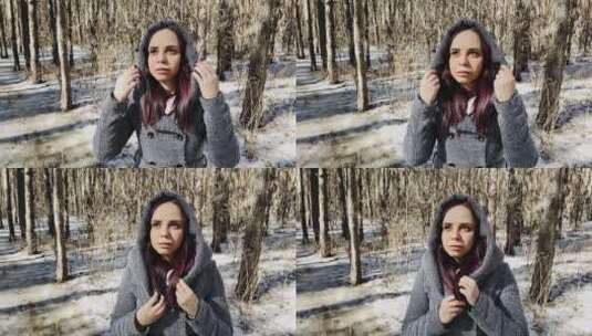 穿着灰色外套的年轻漂亮女人在森林里散步高清在线视频素材下载