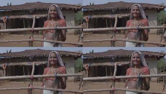 印度村庄栅栏里的女人高清在线视频素材下载