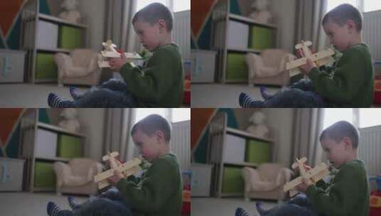 小男孩在玩飞机模型高清在线视频素材下载