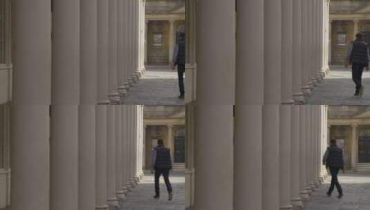 一个男人穿过街上的石柱高清在线视频素材下载