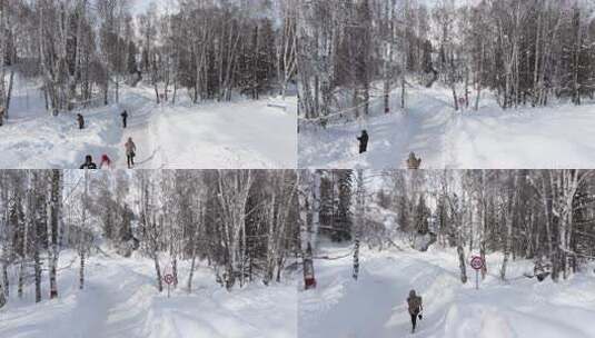 航拍新疆冬季游客在禾木村游玩雪景森林高清在线视频素材下载