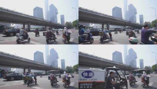 北京国贸城市街道骑电动自行车的人群高清在线视频素材下载