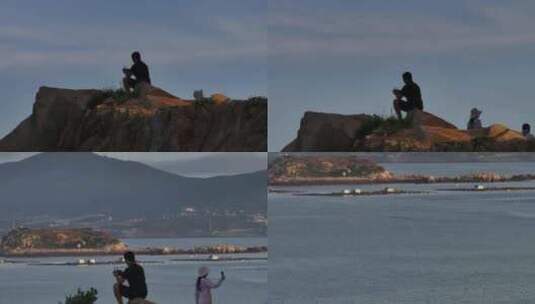 平潭岛在石头顶上的男子高清在线视频素材下载