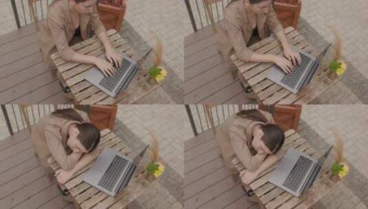 疲劳的女商人坐在她旁边未使用的户外笔记本高清在线视频素材下载