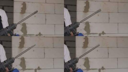 一名建筑工人拿起锤钻并打开它的特写镜头高清在线视频素材下载