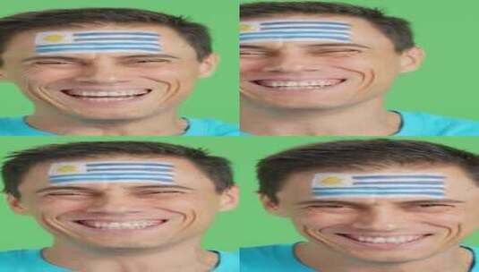 脸上画着乌拉圭国旗微笑的男人高清在线视频素材下载