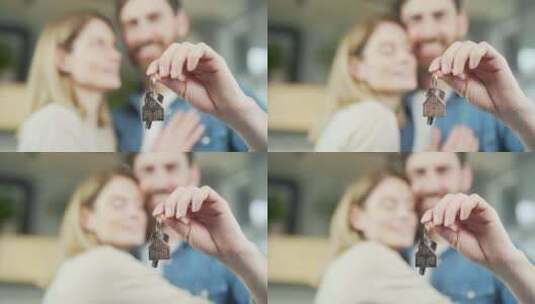 幸福的已婚夫妇拥抱着向镜头展示一串钥匙，高清在线视频素材下载