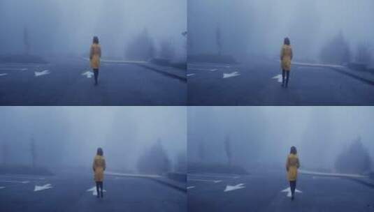 女人 走在大雾弥漫的马路上高清在线视频素材下载