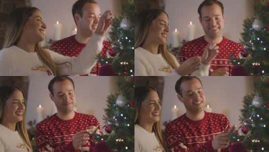 年轻夫妇一起装饰圣诞树高清在线视频素材下载