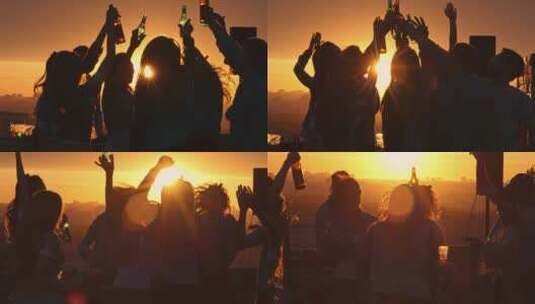 一群朋友在屋顶上喝啤酒夕阳剪影高清在线视频素材下载