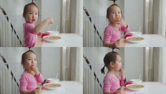 可爱小女孩在家自己吃饭高清在线视频素材下载