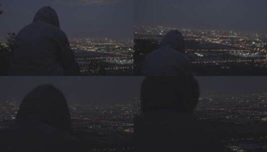 一个人孤独坐在高山看北京夜景享受宁静高清在线视频素材下载