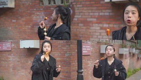 美女游客走在街道吃冰糖葫芦开心吃小吃美食高清在线视频素材下载
