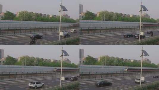 北京6号线地铁列车在地面行驶旁边是高速路高清在线视频素材下载