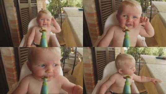 人勺喂养坐在户外高脚椅上的婴儿高清在线视频素材下载