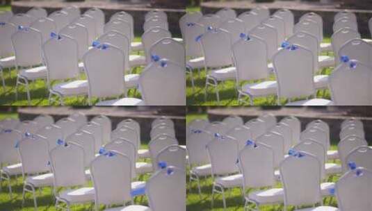 草坪婚礼仪式上空白色椅子的平移镜头高清在线视频素材下载