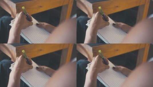 左手拿笔在本上写字高清在线视频素材下载