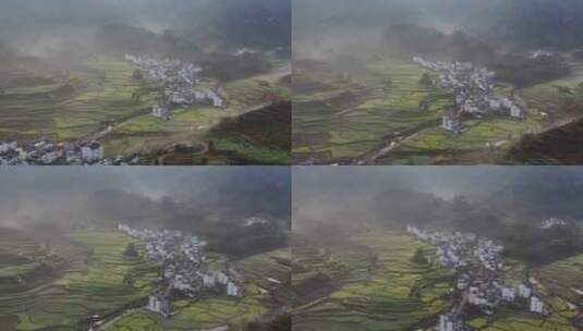 清晨薄雾中的婺源村落及油菜花田的航拍视频高清在线视频素材下载