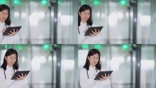 年轻女医生在办公室使用平板工作高清在线视频素材下载