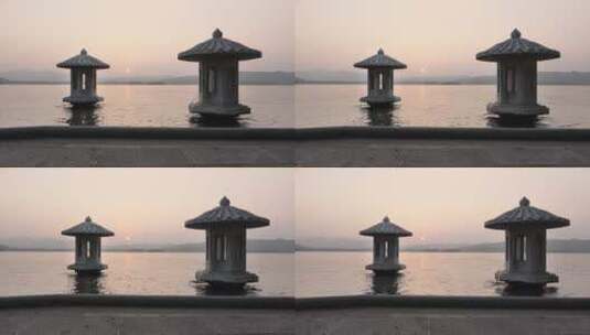 夕阳下波光粼粼的西湖和灯塔高清在线视频素材下载